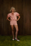 Pink Bloom cotton bloomers from the back, highlighting the all-over smocked texture and ruffled edges.