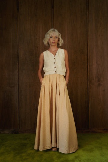 Front view of the Alli Marye Rosemary Skirt in CandyCorn gingham, styled with a cream knit vest.